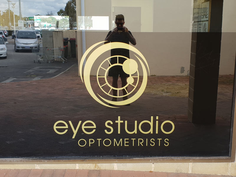 gold vinylc cut letters to outside of tinted window eye stdio optometrists